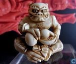 Ivory netsuke of a seated ONI signed KOKU pouring drinks from DOUBLE GOURD Meiji 19th