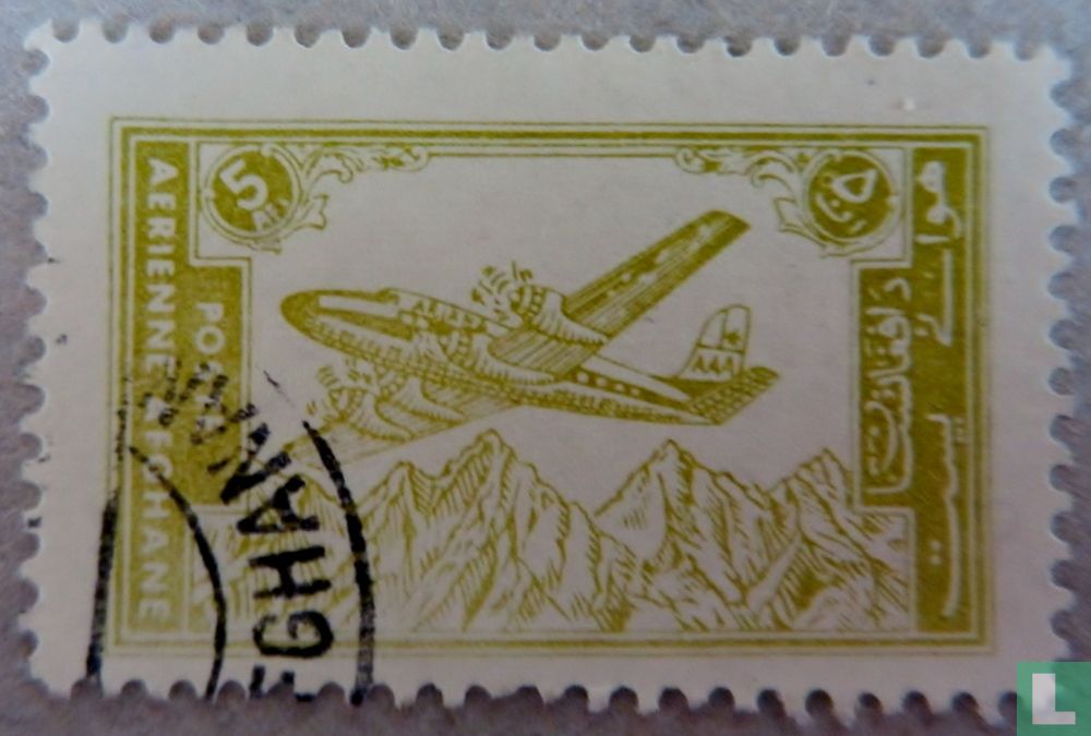 Airplane over mountain range