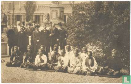 Groep van inlandsche handwerkers met hun geleider in afwachting van de komst van H.M. de Koningin in Artis op 29 Mei 1910