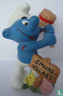Burly smurf with hammer and village sign