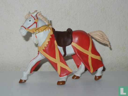 Horse with dressing in red and yellow stripes