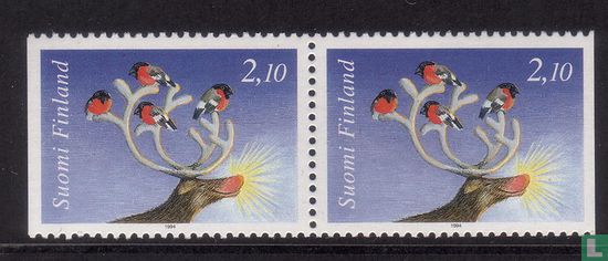 Bullfinches in the antlers of a reindeer