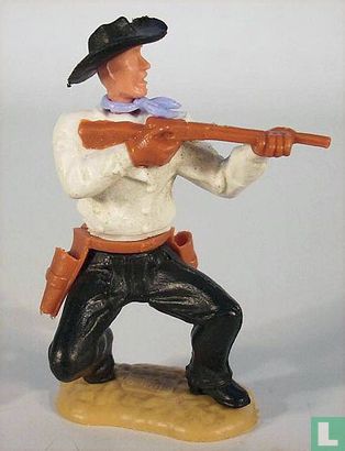 Cow-Boy à genoux avec fusil