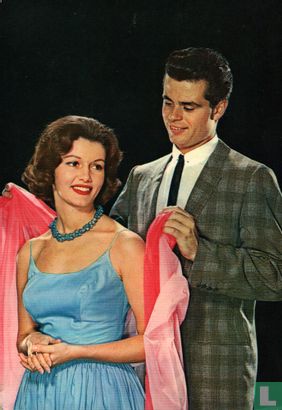Jong stel bij auto - Man geeft jas aan - Vrouw blauwe jurk - Image 1