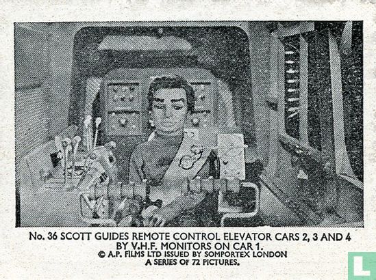 Scott guides remote control elevator cars 2, 3 and 4 by v.h.f.monitors on car 1. - Image 1