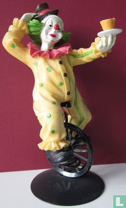 yellow clown on unicycle