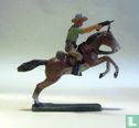 Cowboy on horseback with drawn revolver - Image 1