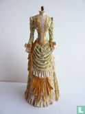 Mannequin with light green dress with Golden details - Image 1