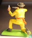 Cowboy kneeling with two guns - Image 2