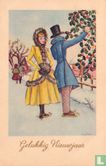 Man en vrouw bij hulst in sneeuwlandschap - Afbeelding 1