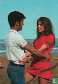 Jong stel op strand - Vrouw rode korte jurk - Afbeelding 1