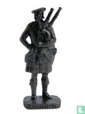 Bagpipe player (bronze)