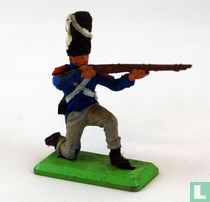 Soldier kneeling and shooting