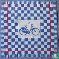 Blue women's bicycle on towel