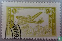 Airplane over mountain range