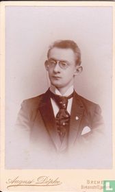 Young man with pinch glasses and spectacle chain