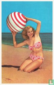 Pin-up vrouw in rood gestippelde bikini met strandbal