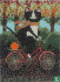 Katze auf rosa Fahrrad