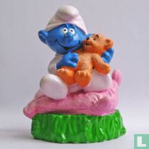 Baby Smurf with teddybear on pillow
