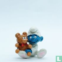 Babysmurf met teddybeer  