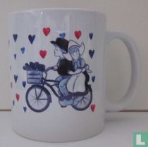Farmer with farmer's wife on bicycle
