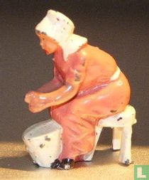Milkmaid sitting on stool