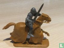 Chevalier à cheval avec épée et bouclier