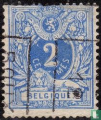 Lying lion with coat of arms