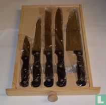 Set of kitchen knives in cutting board