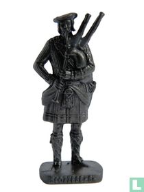 Bagpipe player (bronze)