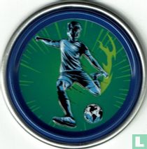 Soccer player kicking the ball away